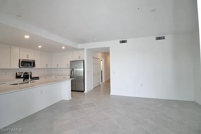 a kitchen with a sink stainless steel appliances and cabinets