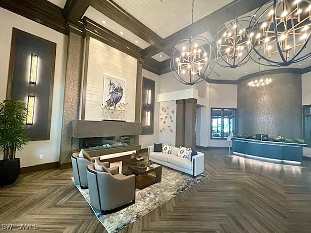 a living room with furniture and a chandelier