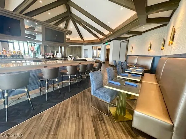 a room with lots of furniture and wooden floors