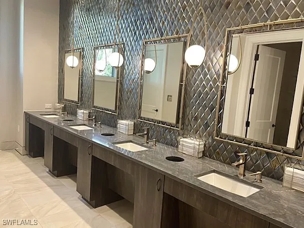 a bathroom with a double vanity sink and a mirror