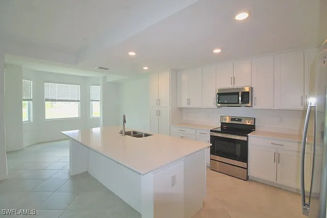a kitchen with a sink stove and refrigerator