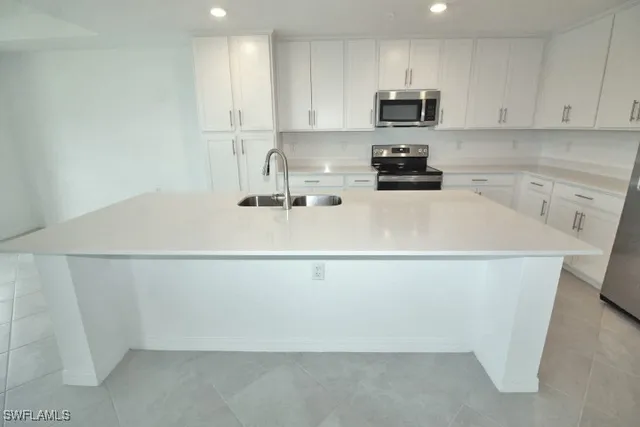a white refrigerator freezer sitting in a kitchen