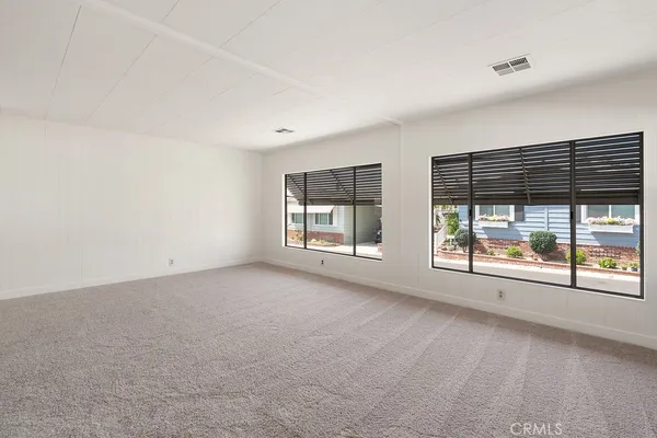 an empty room with windows and view