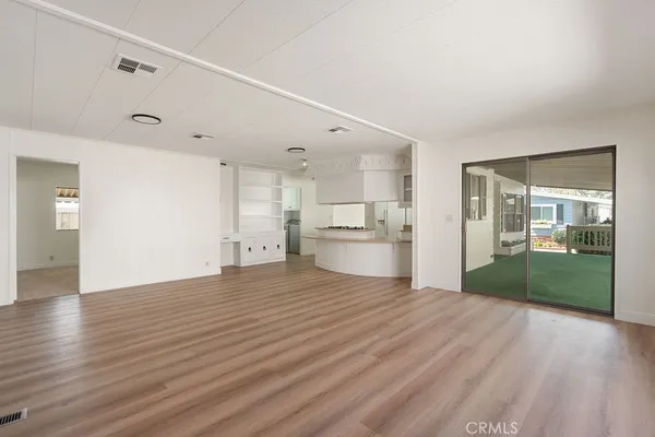 a view of a kitchen with wooden floor and a kitchen