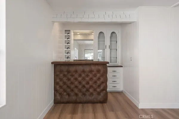 a view of a hallway with wooden floor and a window