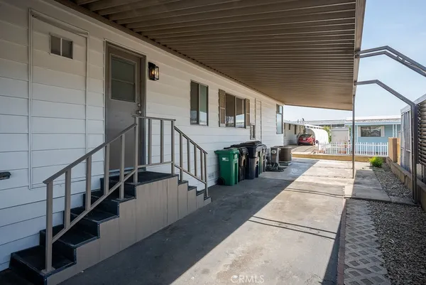 a view of a porch with wooden floor and stairs