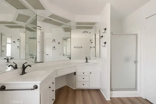 a bathroom with a double vanity sink mirror and