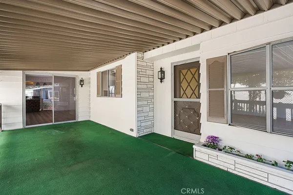 a view of a house with a yard porch and sitting area