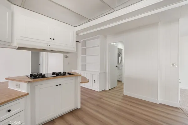 a kitchen with granite countertop a stove a sink and a refrigerator