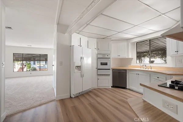 a kitchen with stainless steel appliances a refrigerator sink and cabinets