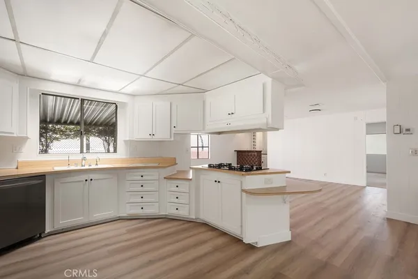 a kitchen with a stove a sink and a refrigerator
