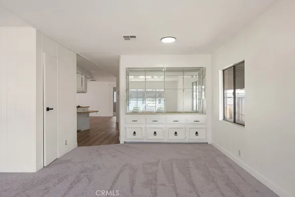 a view of a bedroom with window and cabinet