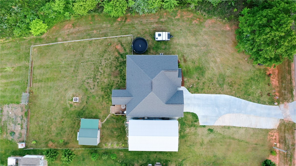696 Mt Olivet Road Six Mile, SC 29682 - Photo 3 of 35 An aerial perspective reveals the expansive property, featuring a house with a vast yard and outbuildings.