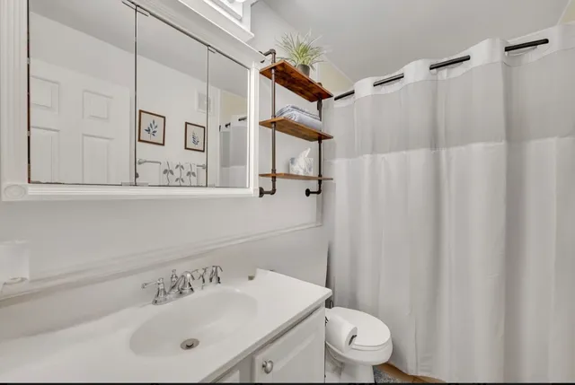 a bathroom with a sink toilet and shower