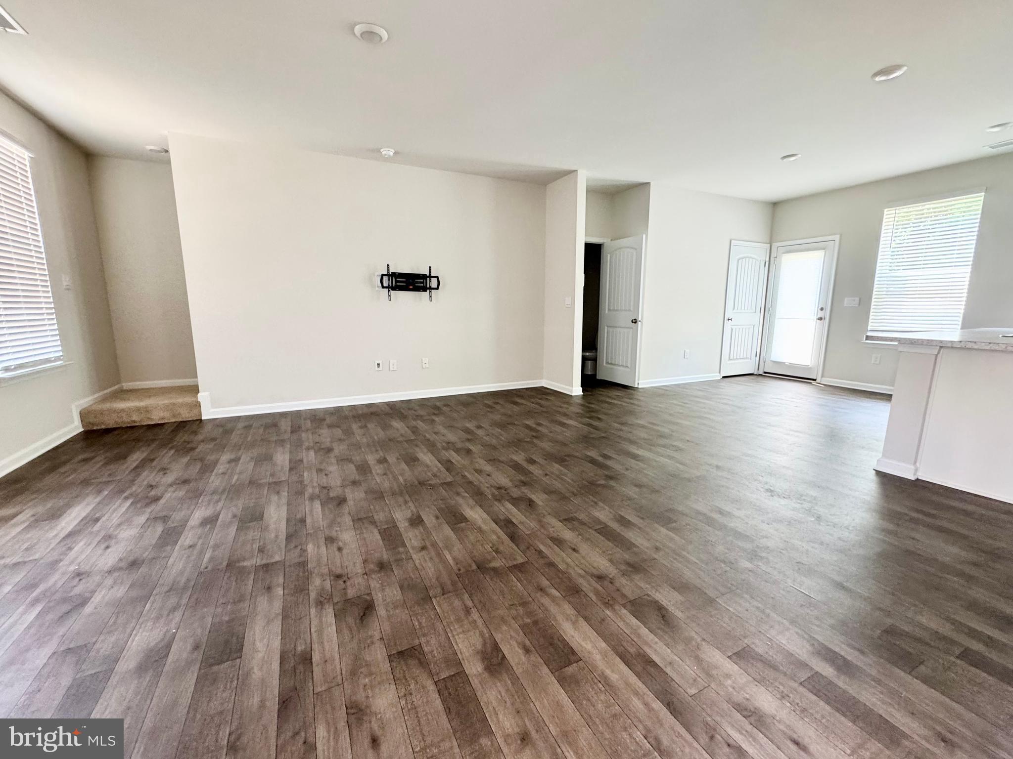 198 Currant Circle Magnolia, DE 19962 - Photo 4 of 19 an empty room with wooden floor and windows