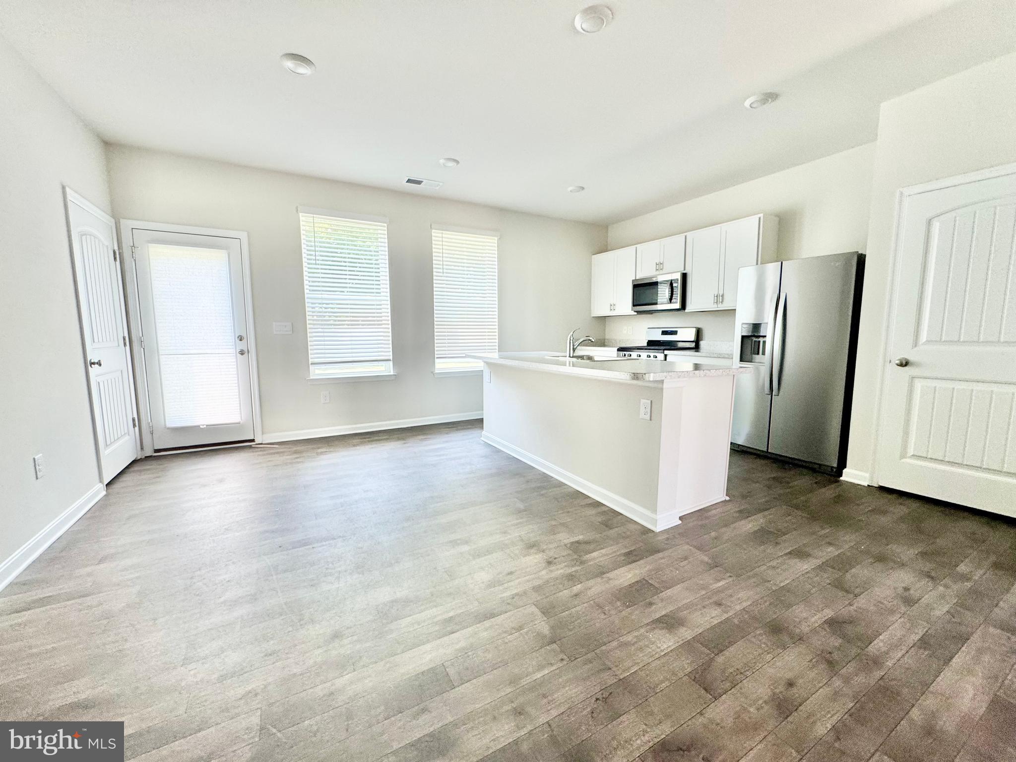 198 Currant Circle Magnolia, DE 19962 - Photo 6 of 19 a view of a kitchen with refrigerator and white cabinets