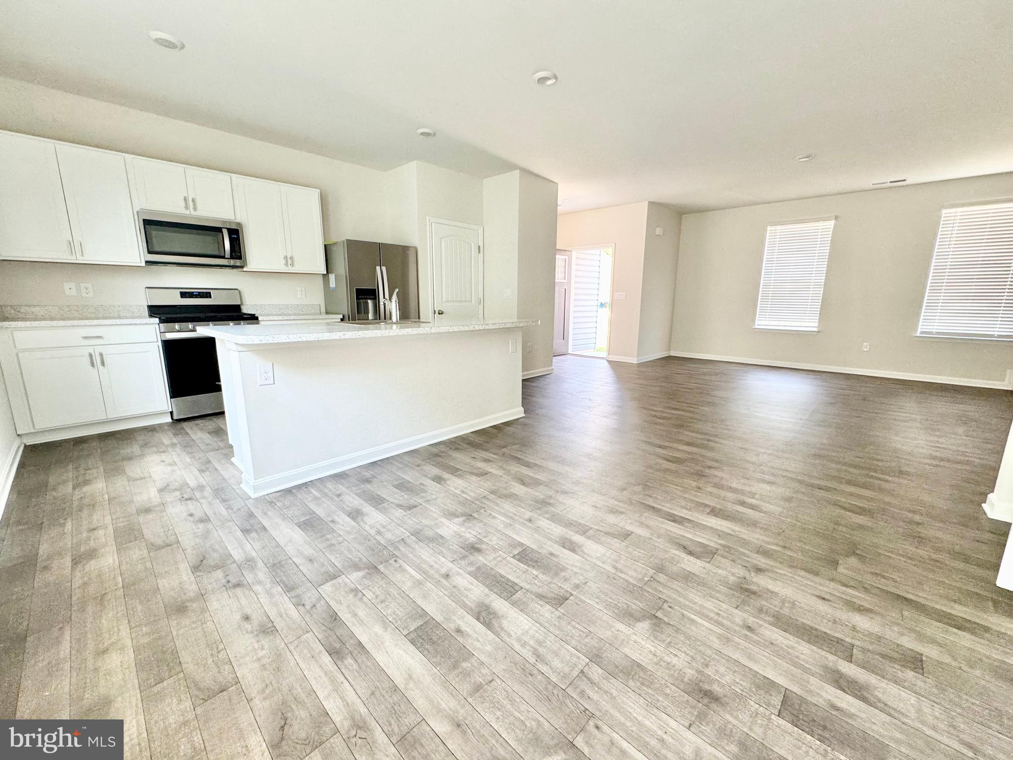 198 Currant Circle Magnolia, DE 19962 - Photo 7 of 19 a view of kitchen with cabinets microwave and stove with wooden floor