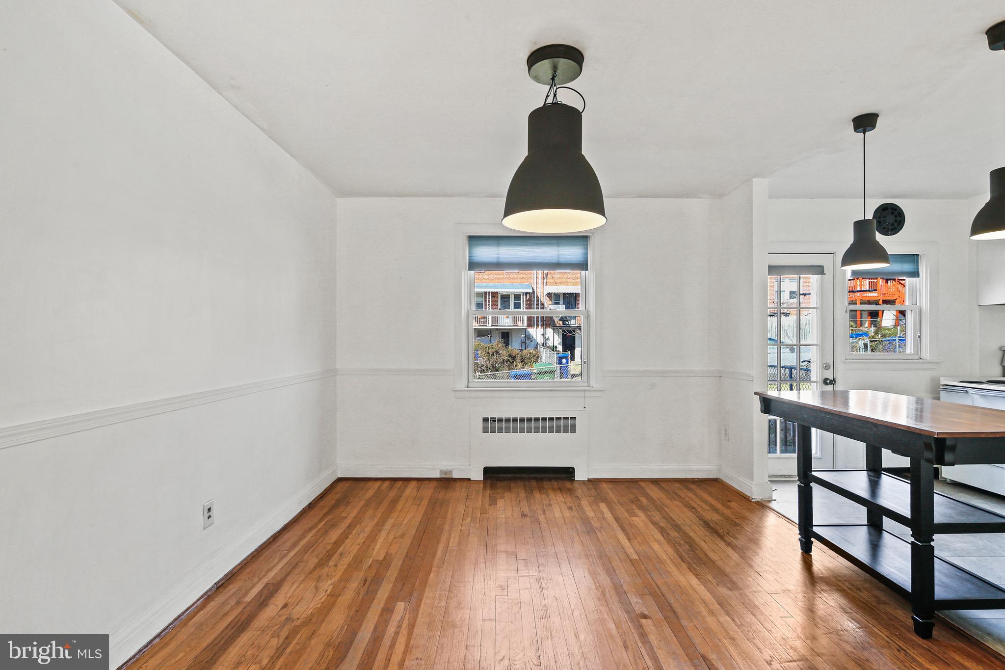 3812 Rexmere Road Baltimore, MD 21218 - Photo 12 of 35 a view of a hallway with wooden floor and furniture