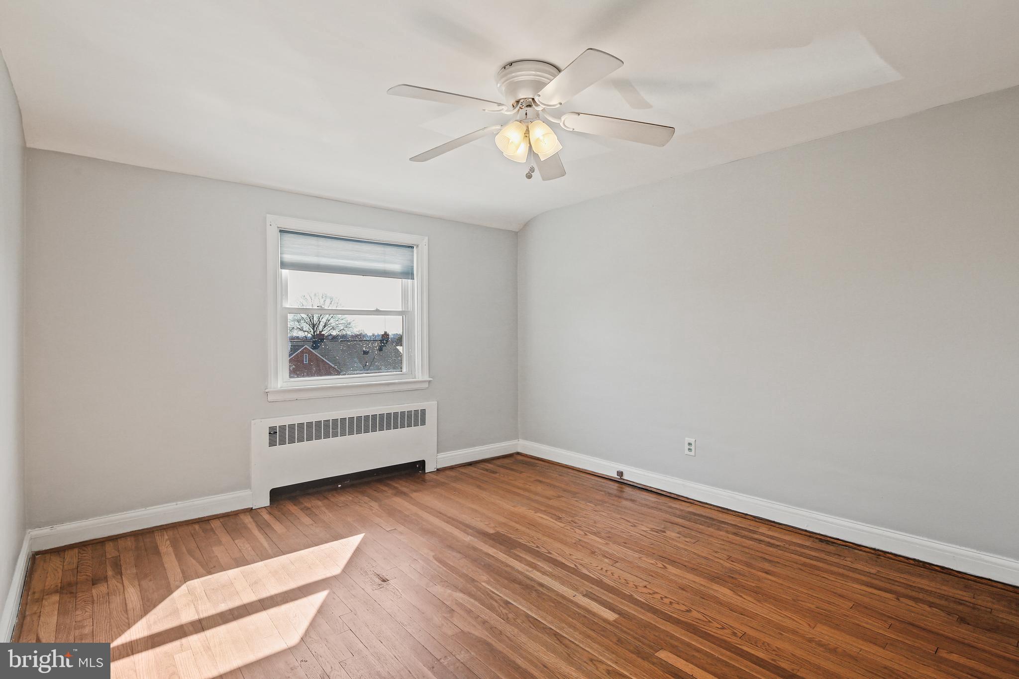3812 Rexmere Road Baltimore, MD 21218 - Photo 14 of 35 wooden floor in an empty room with a window