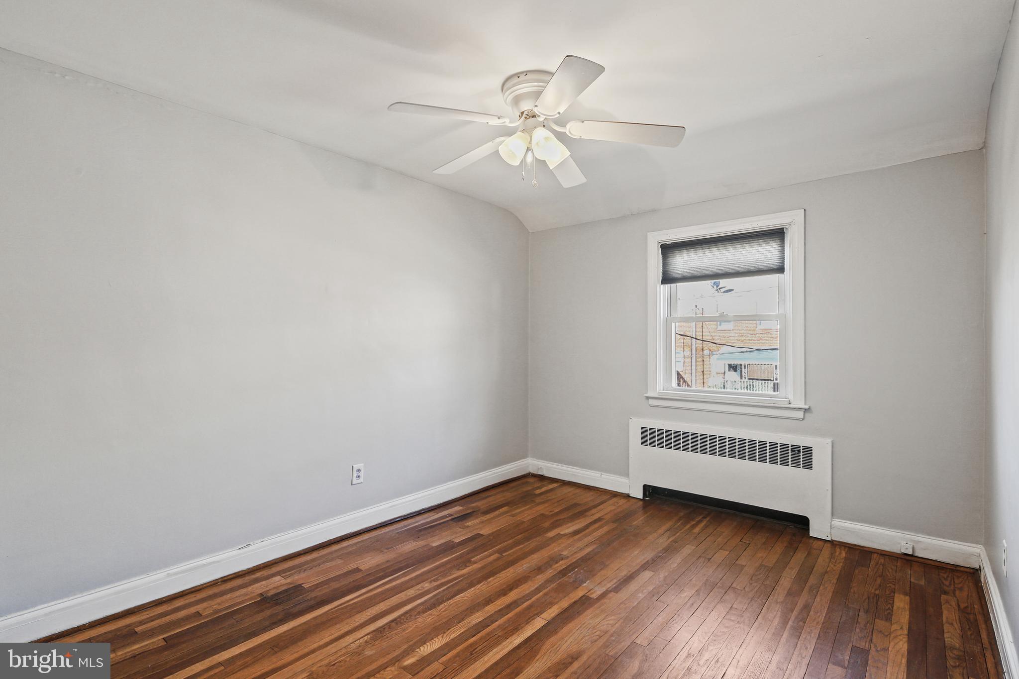 3812 Rexmere Road Baltimore, MD 21218 - Photo 18 of 35 wooden floor in an empty room with a window