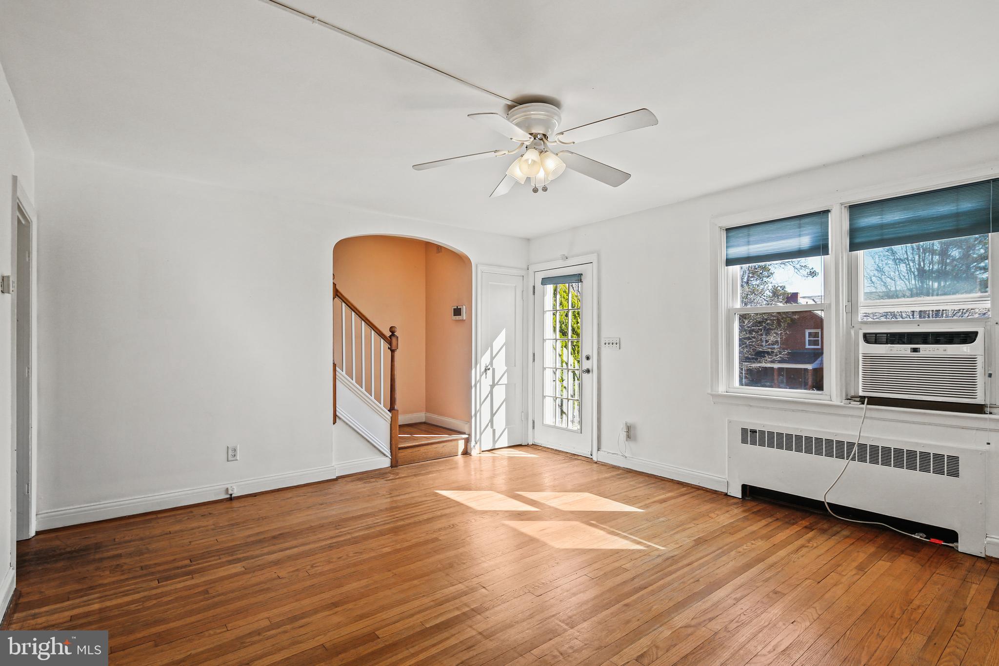 3812 Rexmere Road Baltimore, MD 21218 - Photo 2 of 35 a view of an empty room with a window and wooden floor