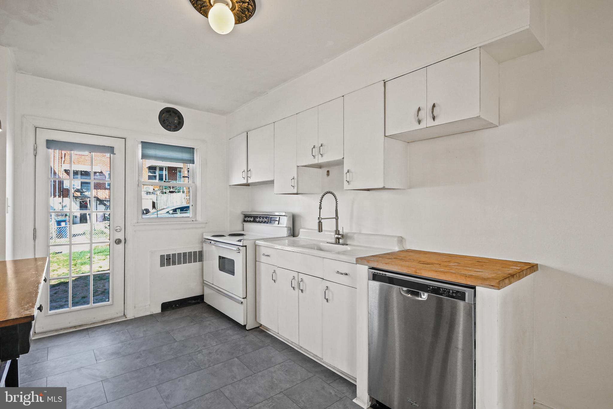 3812 Rexmere Road Baltimore, MD 21218 - Photo 6 of 35 a kitchen with stainless steel appliances granite countertop a sink and cabinets with wooden floor