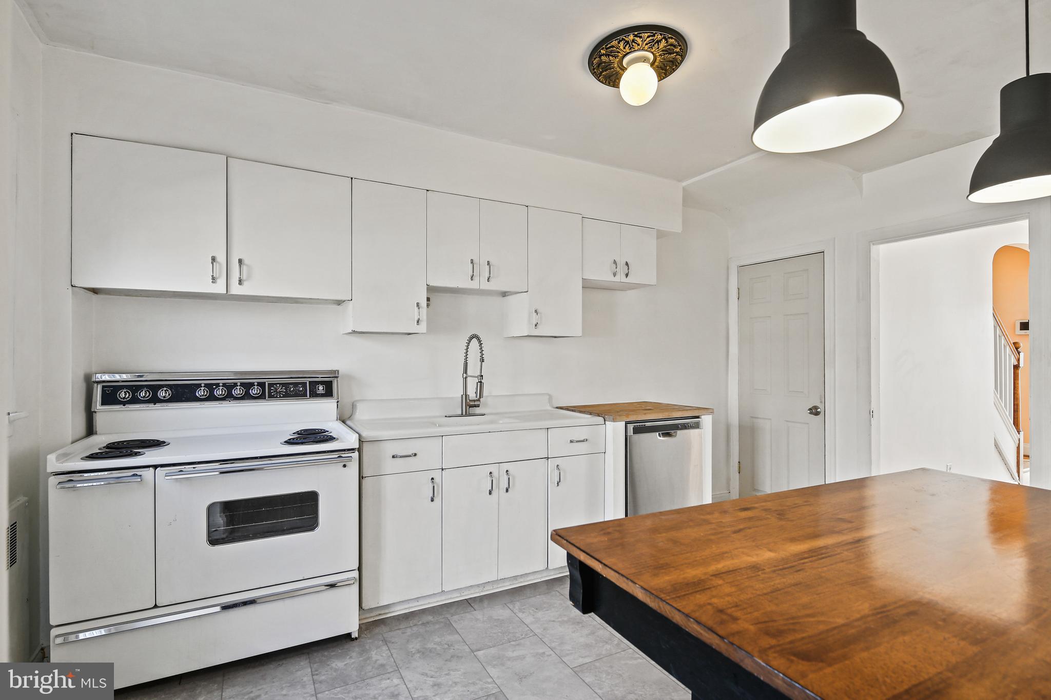 3812 Rexmere Road Baltimore, MD 21218 - Photo 8 of 35 a kitchen with a stove a sink and a refrigerator