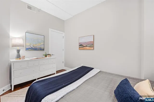 a bedroom with a bed and a dresser