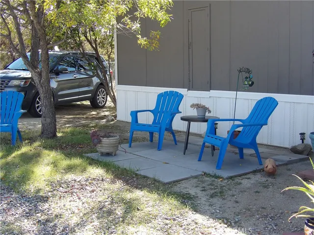 a view of a chairs and table in backyard