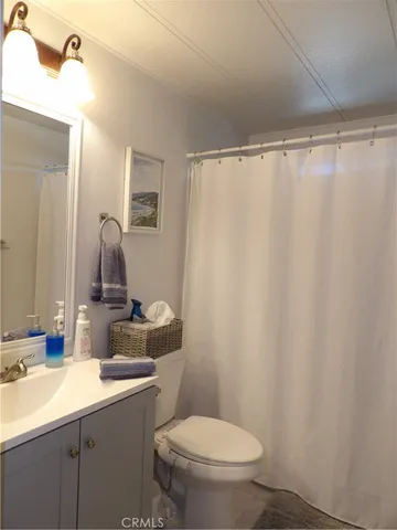 a bathroom with a sink vanity mirror and toilet