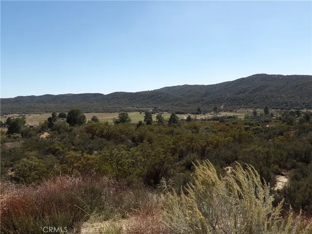 a view of a mountain range with trees in the background