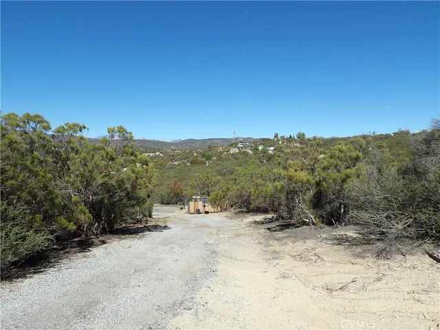 a view of a field with a view of mountains