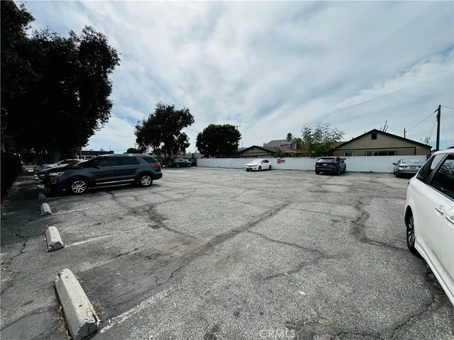 a view of a parking space with cars parked