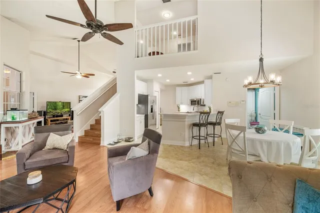a living room with furniture a fireplace and a large window