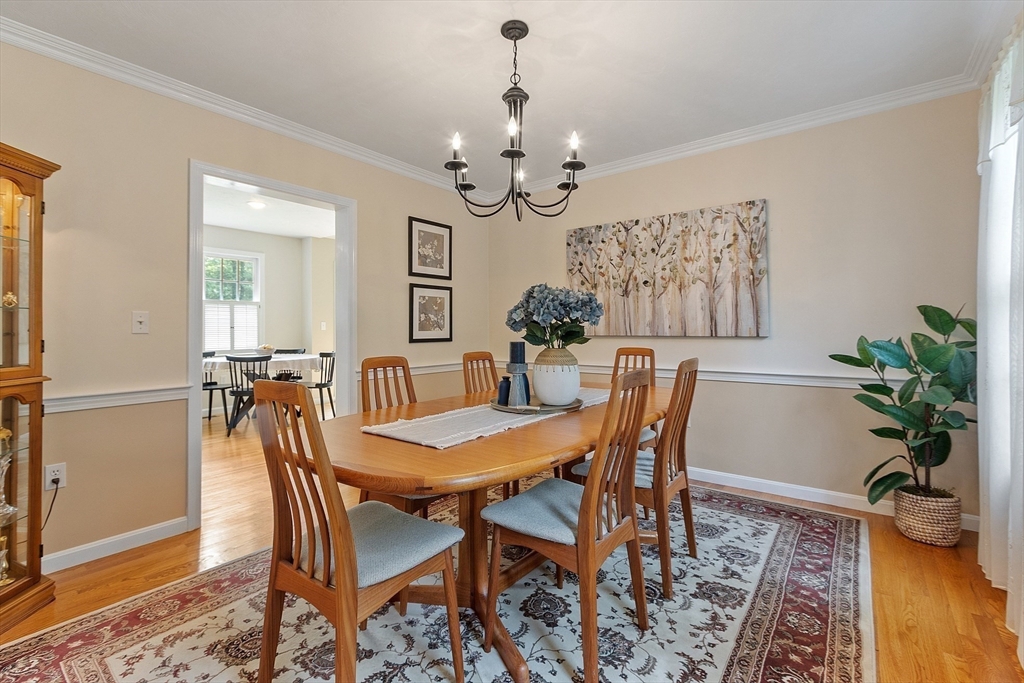 28 Old Harvard Road Boxborough, MA 01719 - Photo 15 of 40 a view of a dining room with furniture and a chandelier