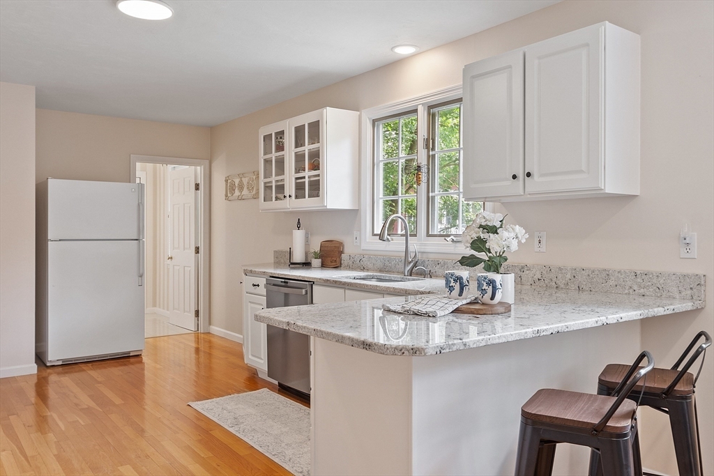28 Old Harvard Road Boxborough, MA 01719 - Photo 9 of 40 a kitchen with stainless steel appliances granite countertop a refrigerator sink and cabinets