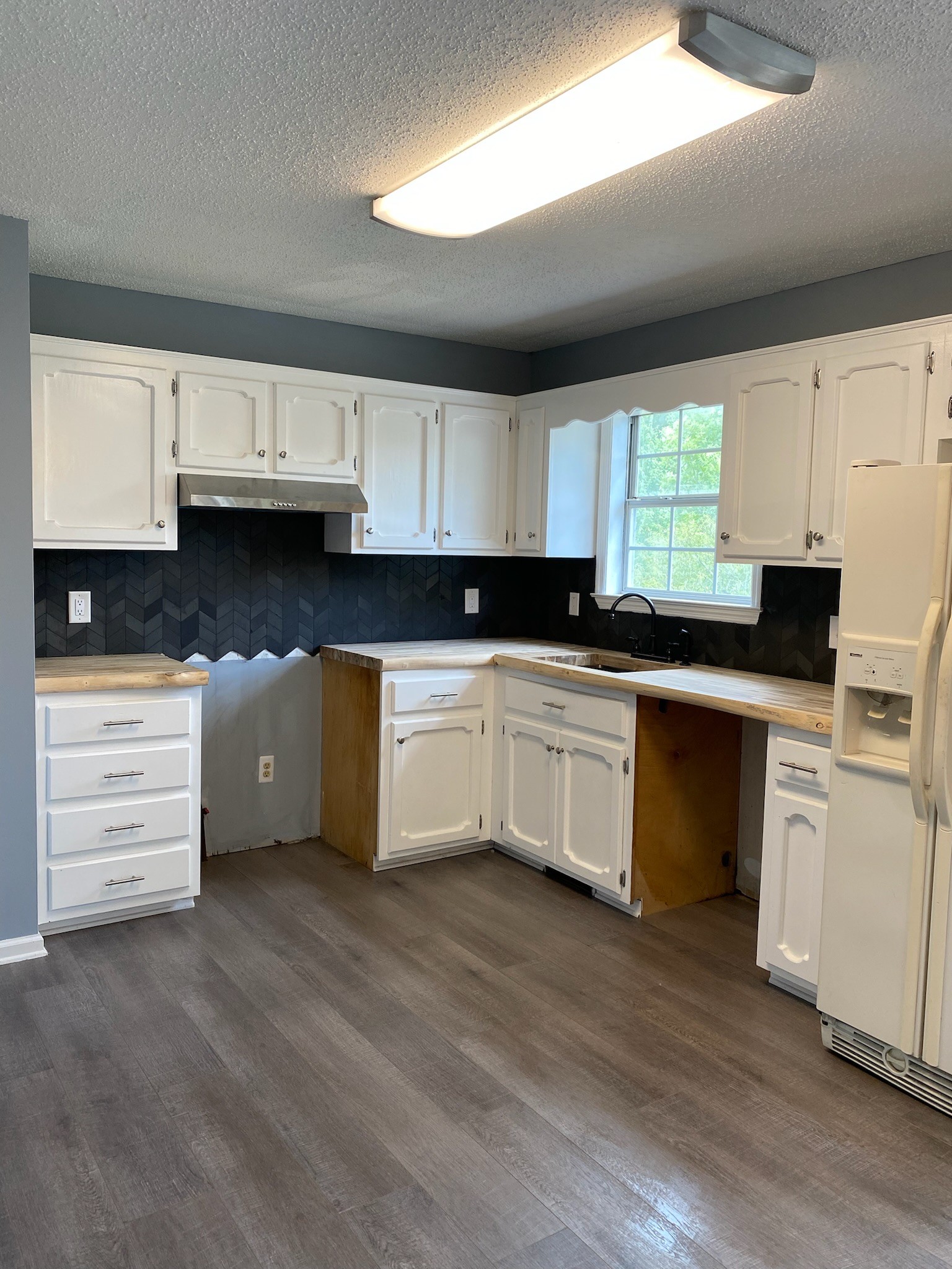 4370 Hardison Mill Road Columbia, TN 38401 - Photo 11 of 37 a kitchen with cabinets a sink a window and appliances