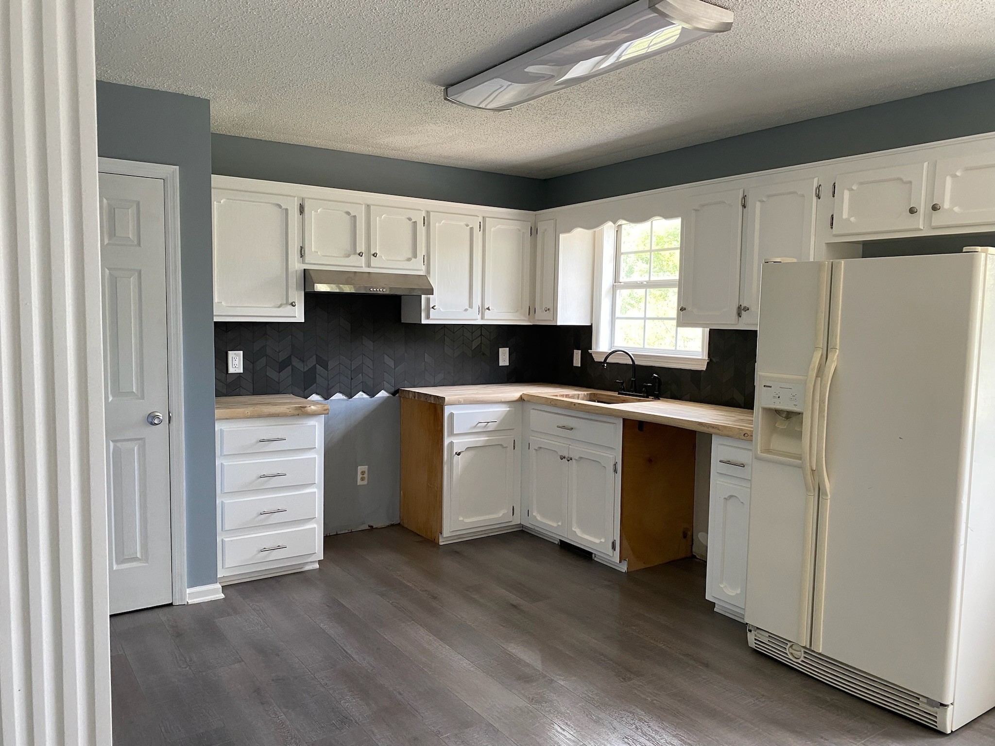 4370 Hardison Mill Road Columbia, TN 38401 - Photo 16 of 37 a kitchen with white cabinets and white appliances