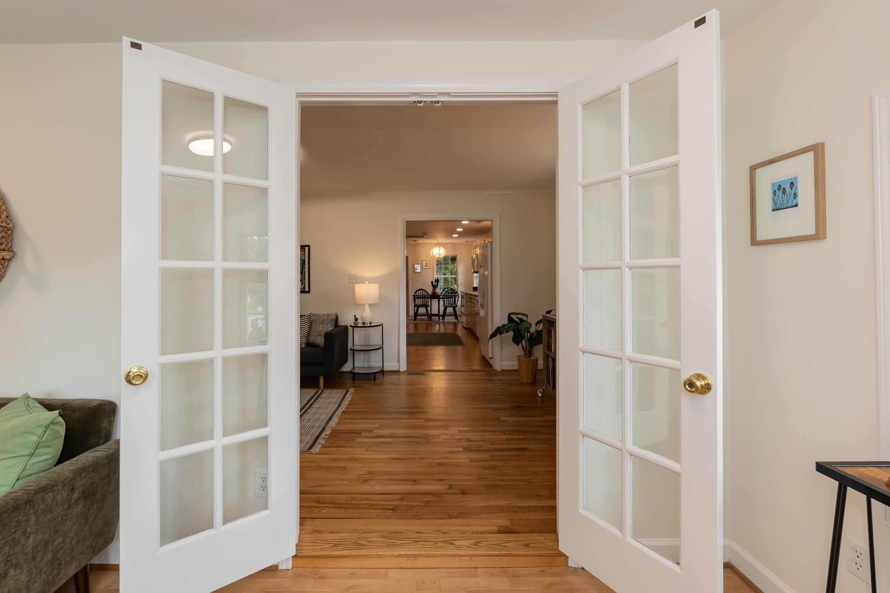 1720 Bennett Street Raleigh, NC 27604 - Photo 8 of 49 French Doors Separate the Living Room from Sun Room