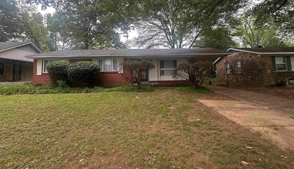 1204 Wilbec Road Memphis, TN 38117 - Photo 1 of 5 Ranch-style home with a porch, driveway, brick siding, and a front yard