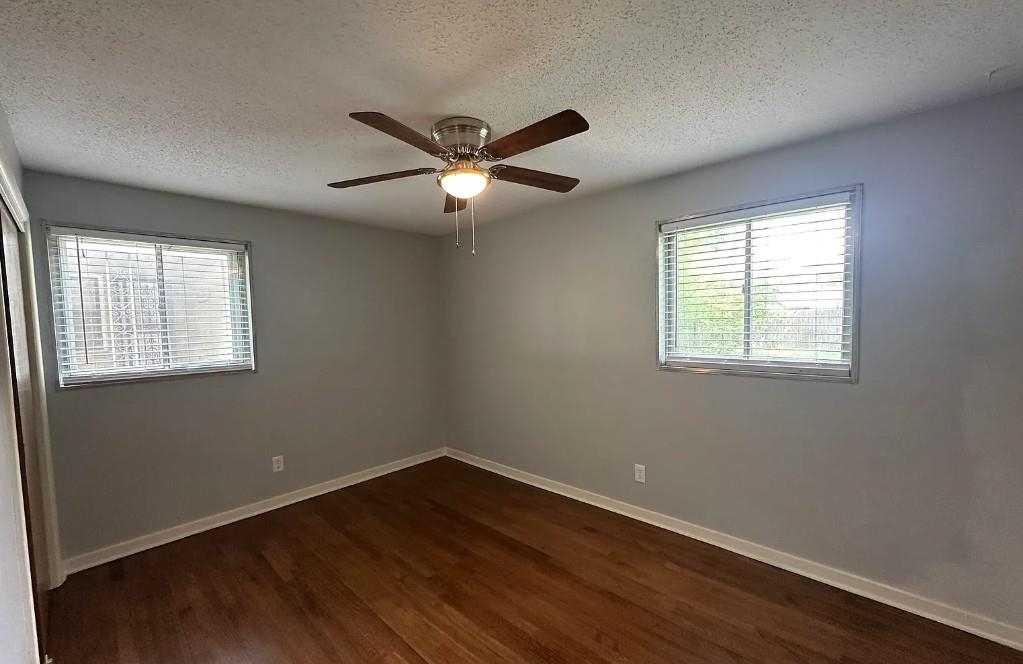 1204 Wilbec Road Memphis, TN 38117 - Photo 4 of 5 Unfurnished room with a textured ceiling, dark wood-type flooring, and a ceiling fan