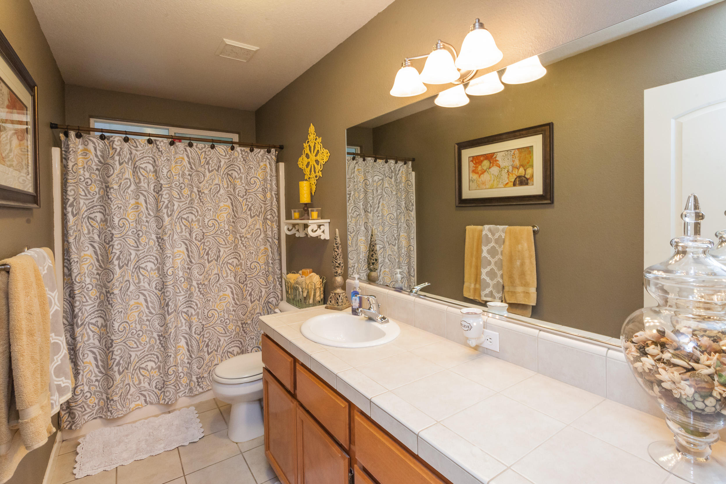 7740 Pit Road Redding, CA 96001 - Photo 11 of 23 a bathroom with a sink vanity mirror and toilet
