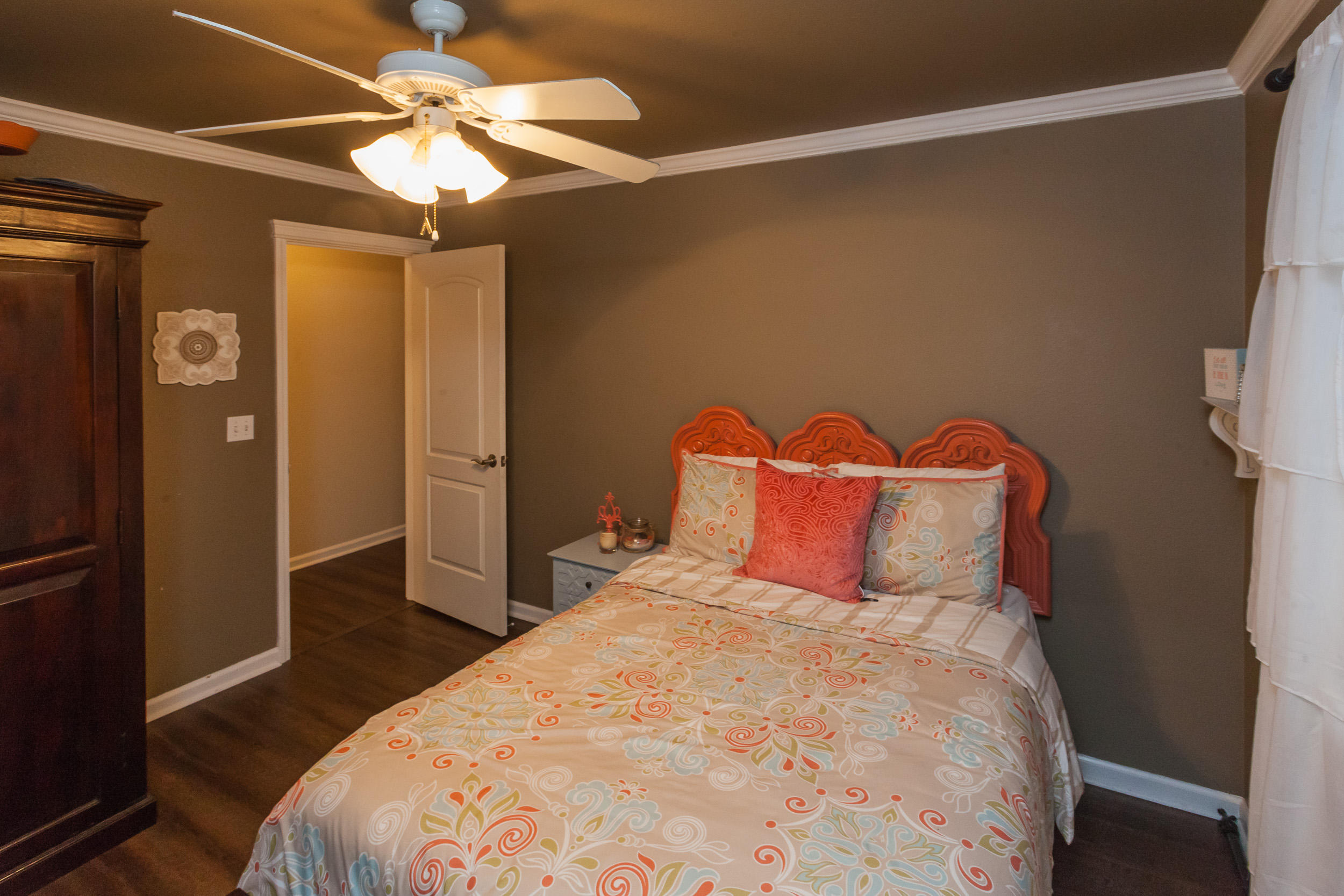 7740 Pit Road Redding, CA 96001 - Photo 13 of 23 a bedroom with a bed and a chandelier