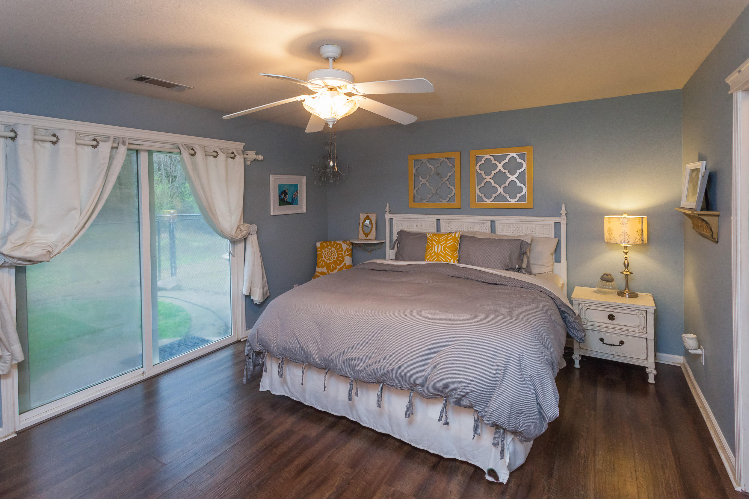 7740 Pit Road Redding, CA 96001 - Photo 14 of 23 a bedroom with a bed and a chandelier