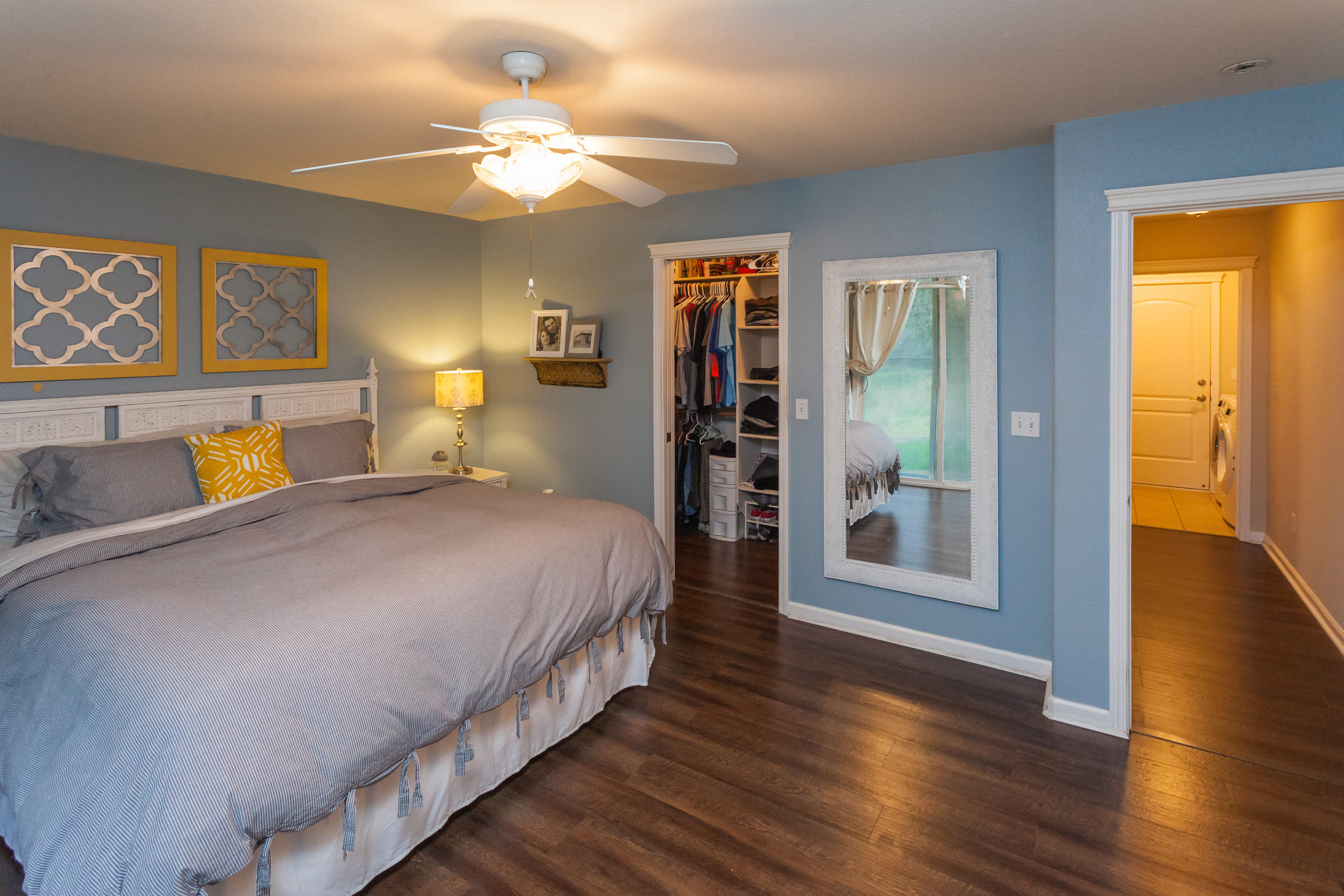 7740 Pit Road Redding, CA 96001 - Photo 15 of 23 a spacious bedroom with a bed and a chandelier