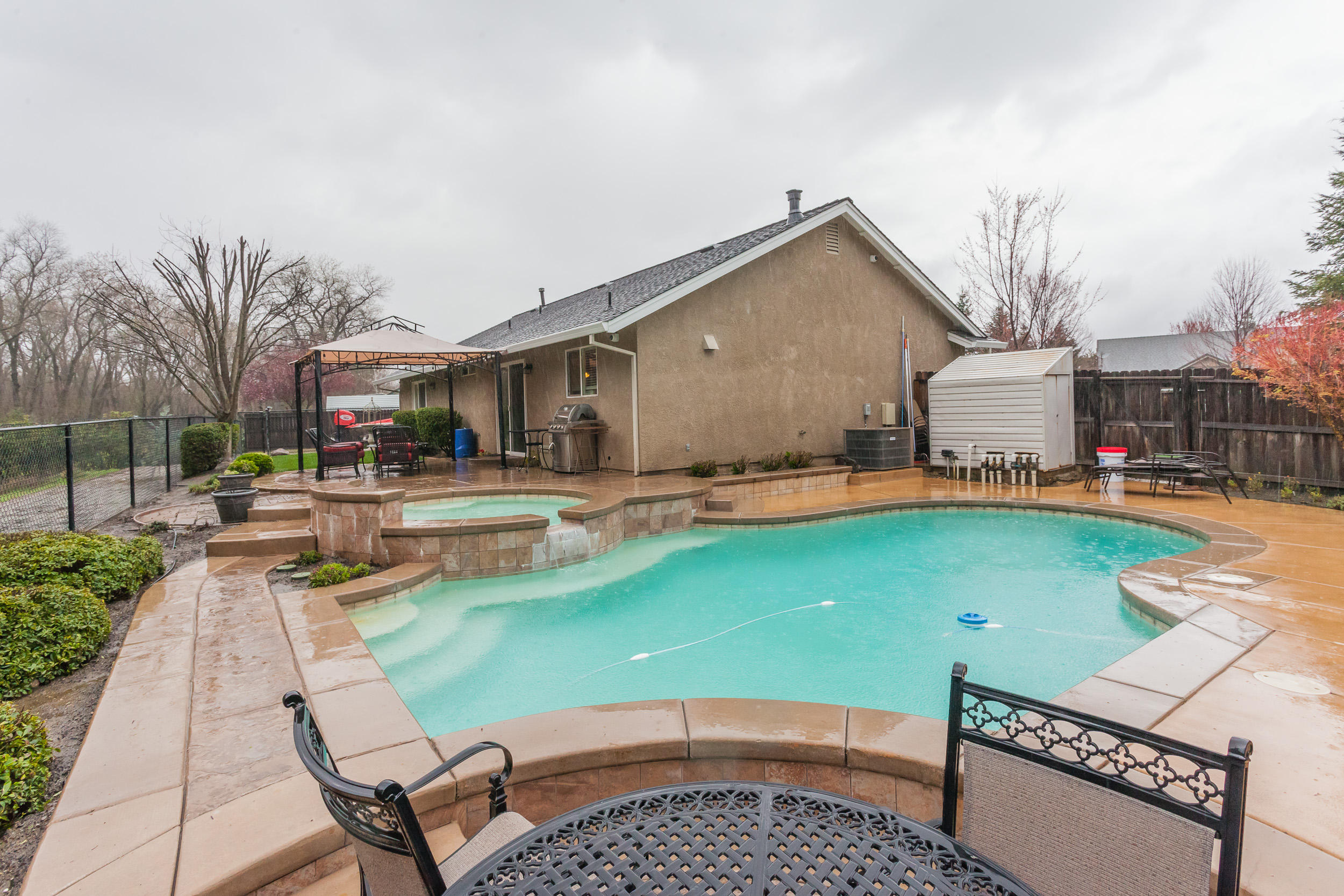 7740 Pit Road Redding, CA 96001 - Photo 20 of 23 a view of a house with swimming pool and sitting area
