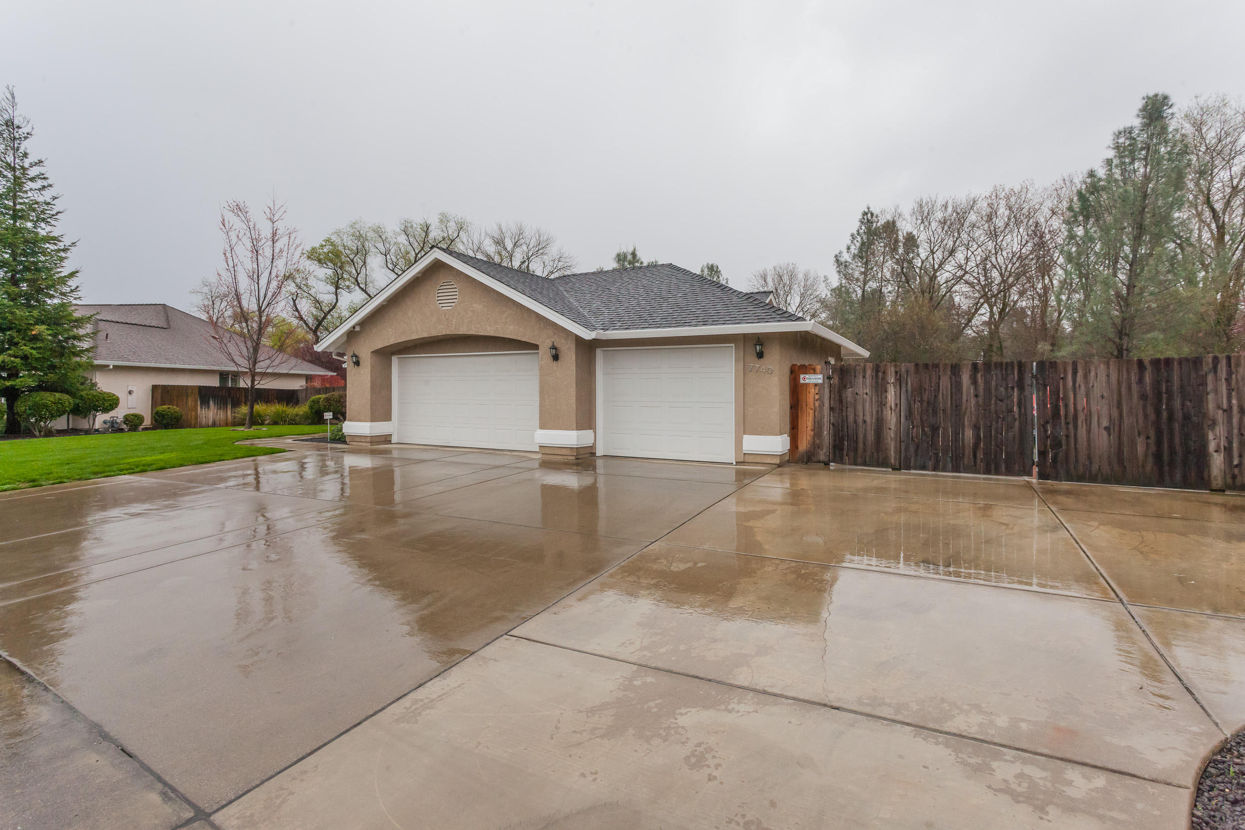 7740 Pit Road Redding, CA 96001 - Photo 3 of 23 a front view of a house with a yard and garage