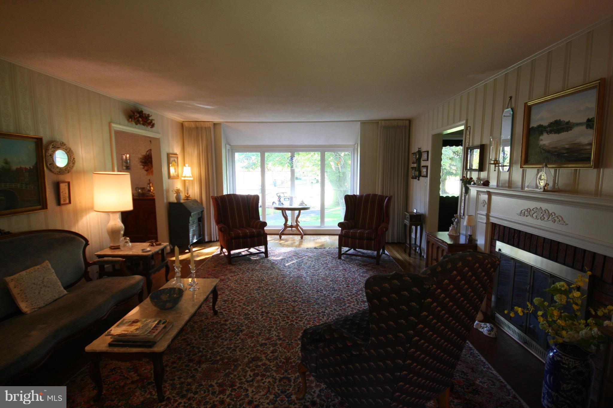 14014 Notley Road Silver Spring, MD 20904 - Photo 13 of 30 a living room with furniture a flat screen tv and a fireplace