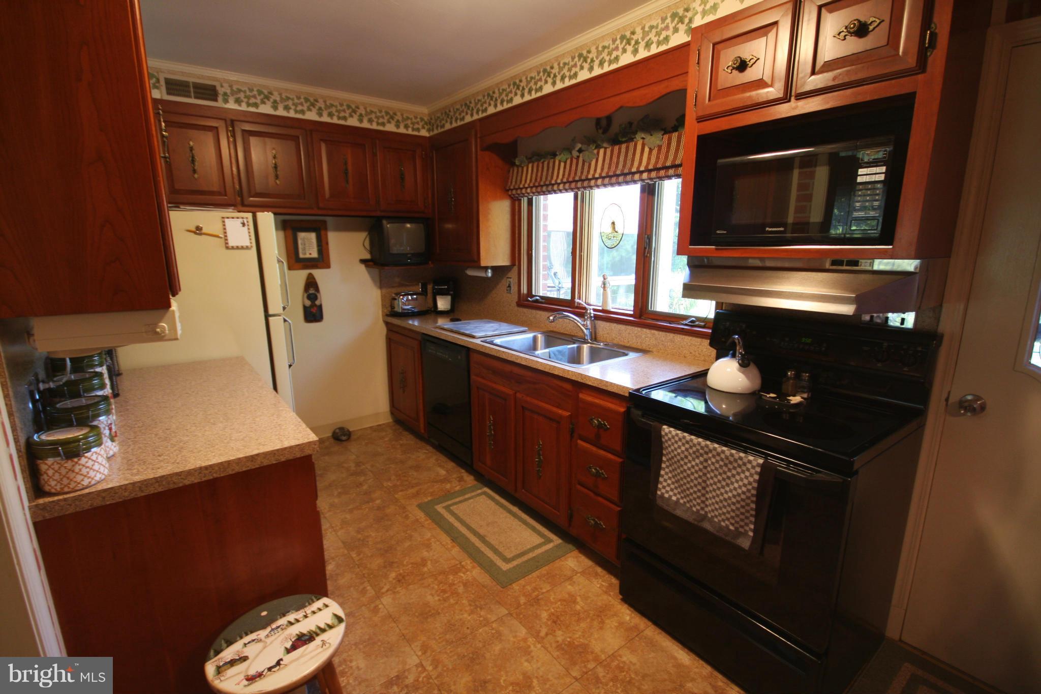 14014 Notley Road Silver Spring, MD 20904 - Photo 17 of 30 a kitchen with granite countertop cabinets and steel stainless steel appliances