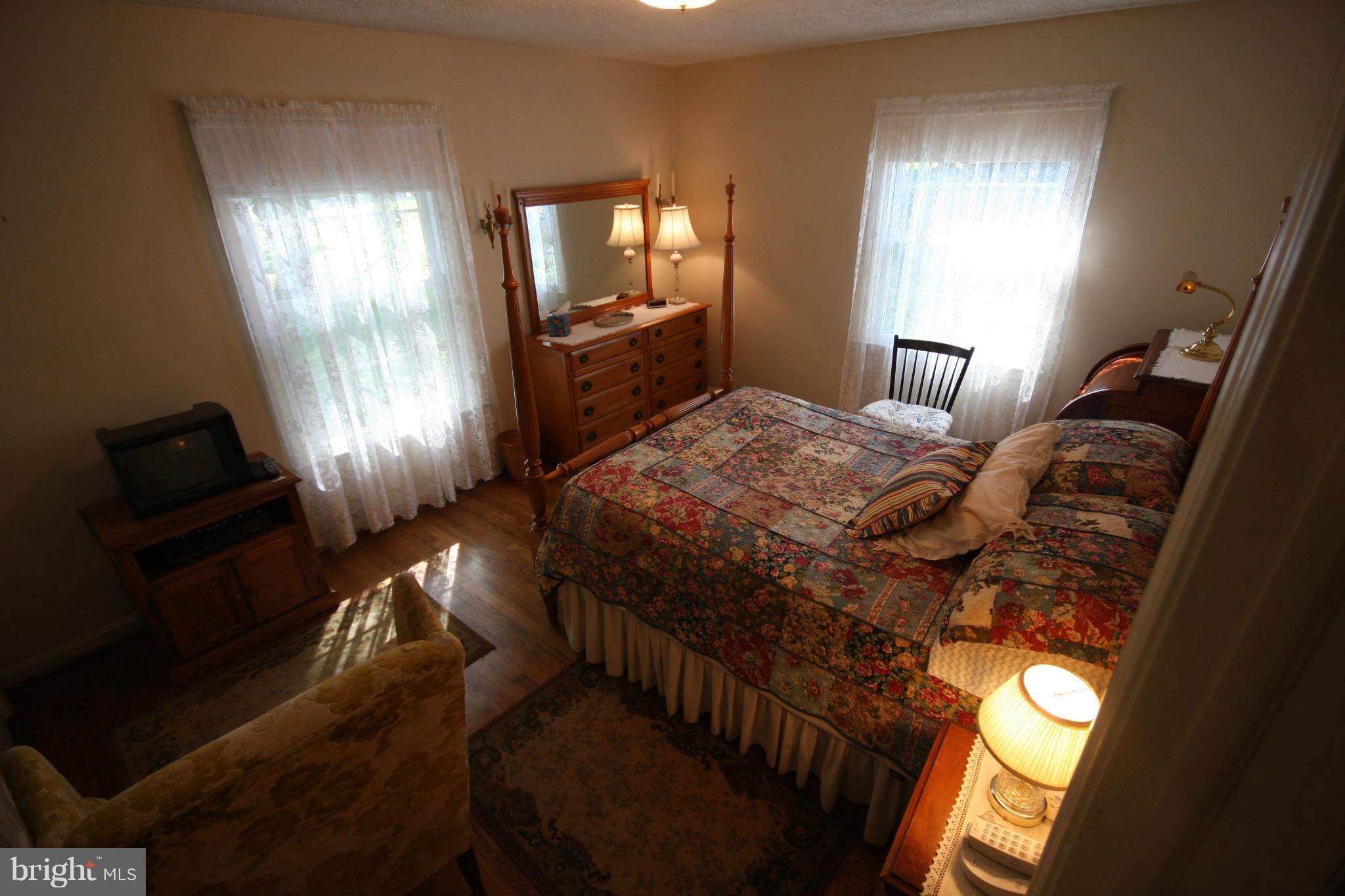 14014 Notley Road Silver Spring, MD 20904 - Photo 19 of 30 a bedroom with a bed and a lamp on dresser